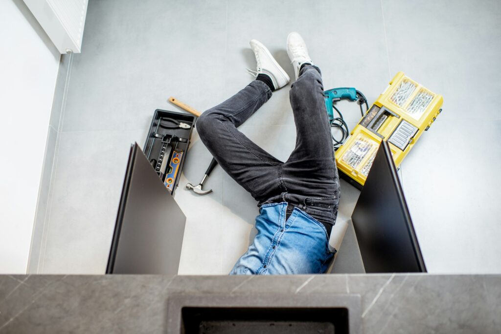 Man repairing kitchen plumbing